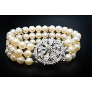 Triple Strand of Cultured Pearls   With 14k White Gold Clasp with 2.5 Carats of Natural Diamonds.   Vintage piece.